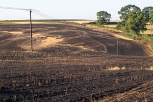The aftermath of a large wheat field fire next to a public footpath in Lane End, Buckinghamshire