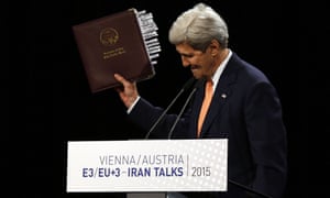 John Kerry, US secretary of state, holds up the Iran nuclear agreement at a press conference in Vienna.