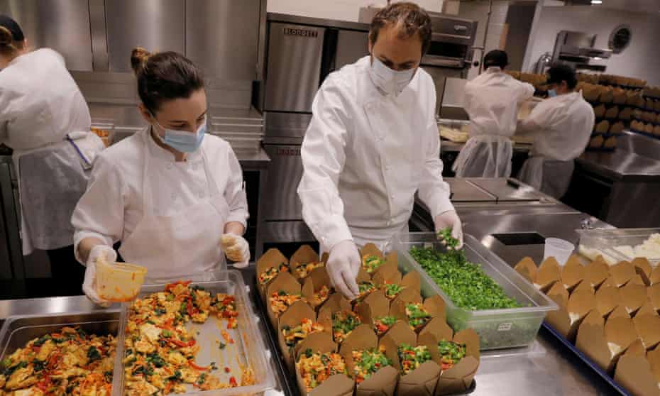 Daniel Humm, right, works to fill to-go boxes of food to donate in the kitchen of Eleven Madison Park in May 2020.