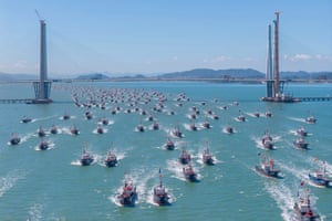 Boats sail out and pass under a bridge