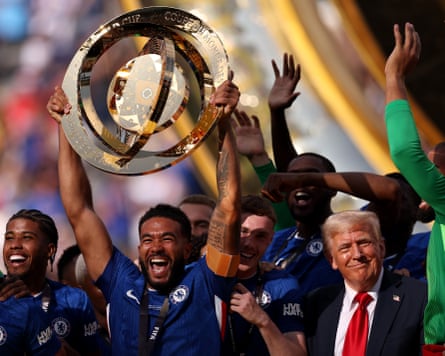 Chelsea FC v Paris Saint-Germain: Final - FIFA Club World Cup 2025<br>EAST RUTHERFORD, NEW JERSEY - JULY 13: Reece James #24 of Chelsea FC lifts the FIFA Club World Cup trophy after their team's victory as U.S. President Donald Trump reacts following the FIFA Club World Cup 2025 Final match between Chelsea FC and Paris Saint-Germain at MetLife Stadium on July 13, 2025 in East Rutherford, New Jersey. (Photo by Justin Setterfield - FIFA/FIFA via Getty Images)