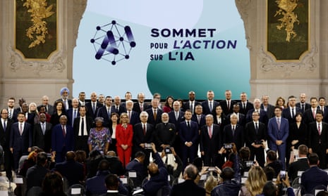 Attendees pose for a family photo with heads of state and government and business leaders after the plenary session of the Artificial Intelligence (AI) Action Summit at the Grand Palais in Paris.