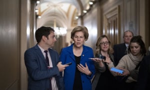 Elizabeth Warren is surrounded by reporters during the impeachment trial of Donald Trump at the Capitol in Washington DC, on 28 January.