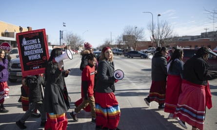 People participate in a march in downtown Rapid City, South Dakota, 14 February 2019, to call attention to missing and murdered Native American women and girls.