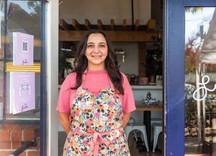 woman smiles in front of restaurant