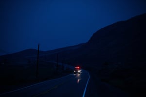 Ashcroft, Canada: A fire truck travels on Highway 97C at dusk as crews battle wildfires in the area.