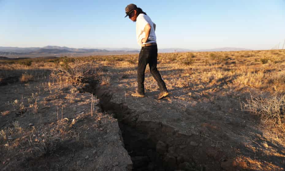 A local resident inspects a fissure in the earth after an earthquake struck the area near Ridgecrest, California, on 4 July. 