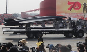 Military vehicles roll down as members of a Chinese military honour guard march during the parade to commemorate the 70th anniversary of the founding of Communist China in Beijing