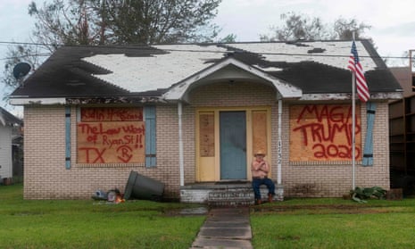 A man rests in front of his house after the passing of Hurricane Laura in Lake Charles, Louisiana on August 27, 2020.