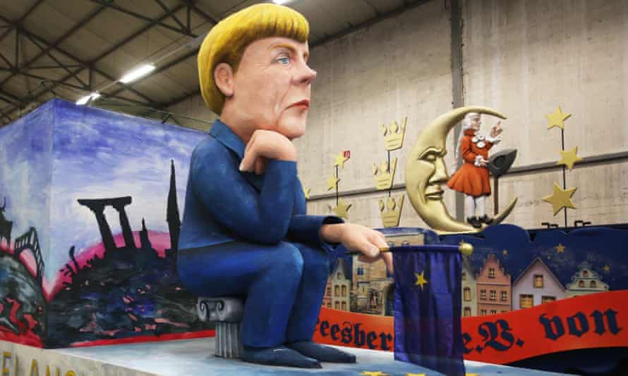 A float featuring a depiction of the German chancellor Angela Merkel is ready for a carnival in Cologne.