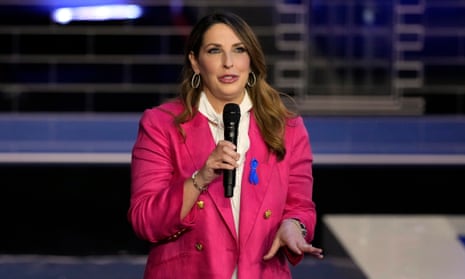 Woman wearing pink speaks into a microphone