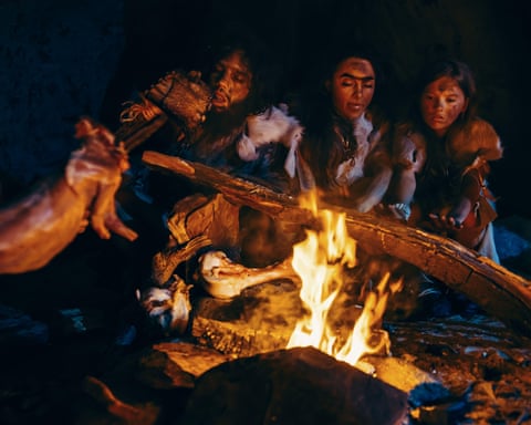 Early humans cooking meat over a fire