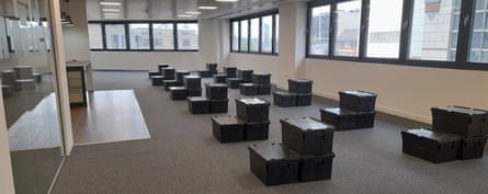Stacks of nondescript black boxes arranged in neat lines