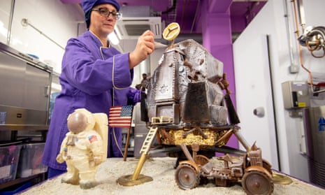 A chocolatier adds the finishing touches to a chocolate recreation of the Apollo 11 moon landing at Cadbury World