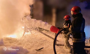 Ukrainian emergency services personnel work to extinguish a fire in the country’s western Ivano-Frankivsk region after Russian attacks on energy facilities