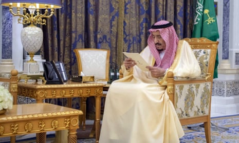 King Salman reads a document as he receives two newly appointed Saudi ambassadors at his palace.
