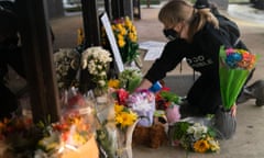 Eight Dead After Shootings At Three Atlanta-Area Spas<br>ACWORTH, GA - MARCH 17: Shelby Swan adjusts flowers and signs outside Youngs Asian Massage where four people were shot and killed on March 17, 2021 in Acworth, Georgia. Suspect Robert Aaron Long, 21, was arrested after a series of shootings Tuesday night at three Atlanta-area spas left eight people dead, including six Asian women. (Photo by Elijah Nouvelage/Getty Images)