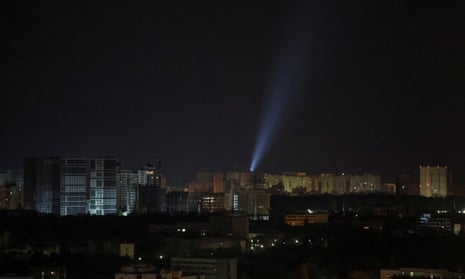 Ukrainian servicemen use searchlights to look for drones in the sky over Kyiv.
