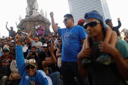 Central American migrants, moving in a caravan through Mexico, gesture in a demonstration at Angel de la Independencia monument in Mexico City, 12 April