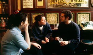 Customers enjoying a drink in McDaids pub, Dublin, Ireland.
