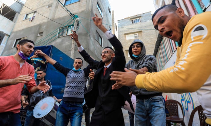 Palestinian groom Mohammed Ahmed Ashour dances with male relatives and friends while waiting for his bride during his wedding ceremony amid the Covid-19 pandemic, in Gaza City.