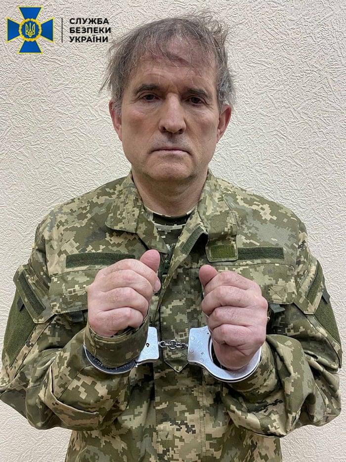 Dishevelled man in camouflage uniform and handcuffs