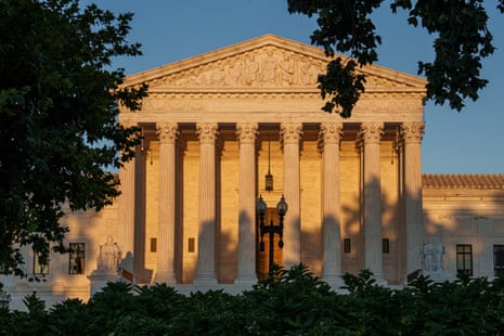 Sunset light bathes the US Supreme Court's columned façade, framed by trees