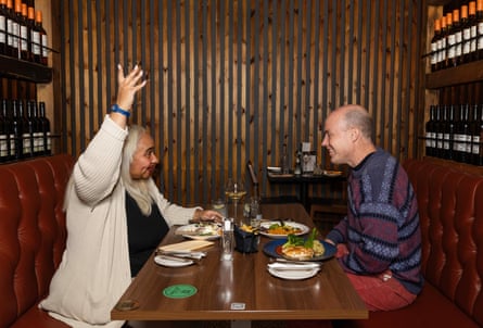 Maxine and Fred chatting at a restaurant table