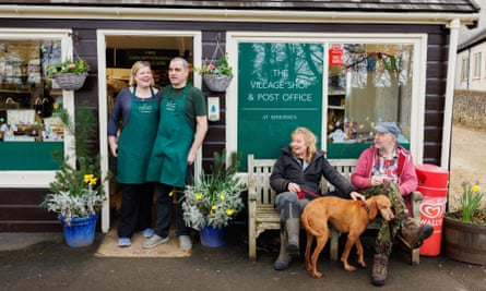 Some people take a seat outside Miserden Stores, the village shop Jonathan and Laura Cobb own in Gloucestershire.