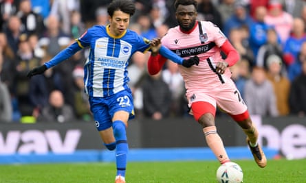 Grimsby's Michee Efete (right) battles with Kaoru Mitoma