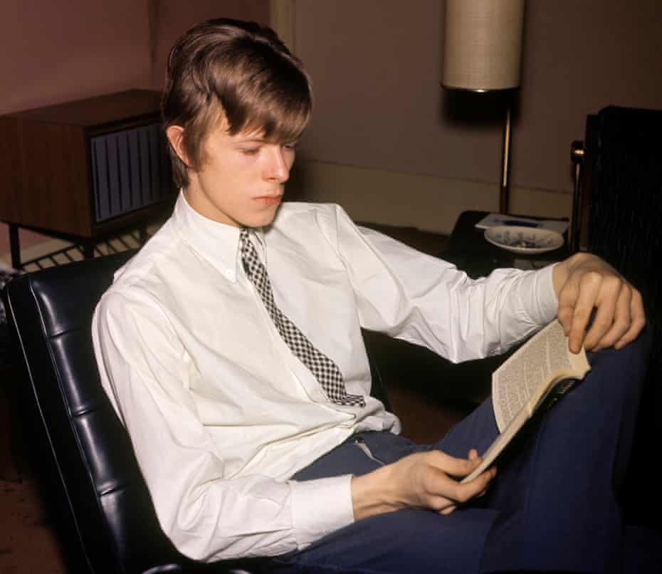 David Bowie reading a book, in 1995. 