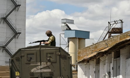 A Russian serviceman guarding a grain elevator in Melitopol on 14 July.