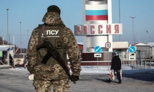 A member of the Ukrainian border guard service at a crossing point on the border between Russia and Ukraine in the Kharkiv region.