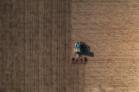 A tractor harrowing farmland in Lieto, Finland.