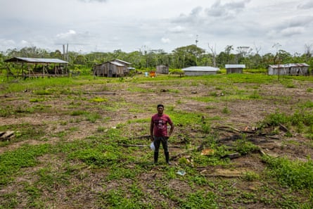 Jesús Chalá stands next to the remains of the collapsed and abandoned houses due to the river overflow over the past years.