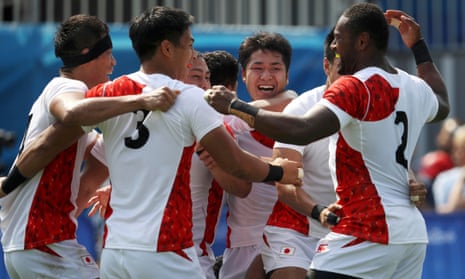 Japan celebrate after defeating New Zealand.