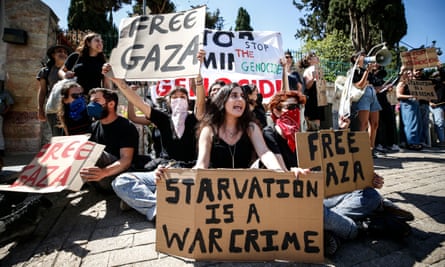 Mostly young protesters hold placards and banners with messages including 'Free Gaza', 'Starvation is a war crime' and 'Stop the genocide'