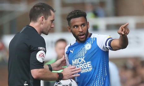 Peterborough’s Nathan Thompson talks to referee Jarred Gillett.