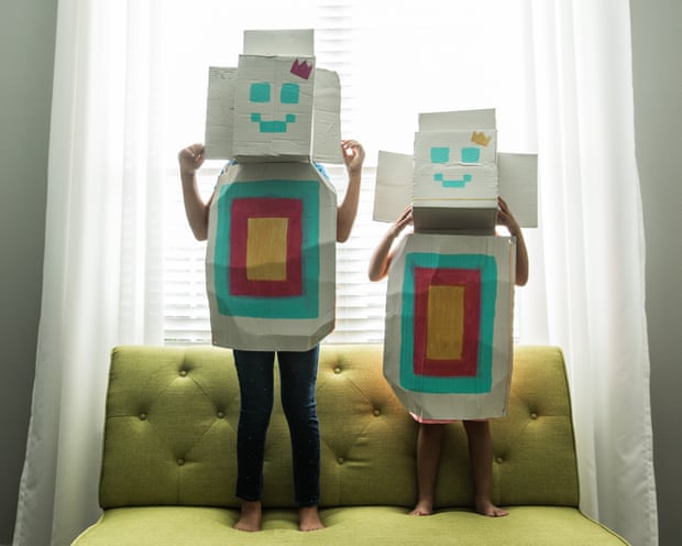 Young girls wearing homemade robot costumes at home