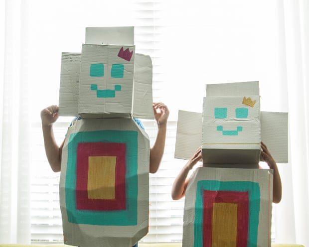 Young girls wearing homemade robot costumes at home