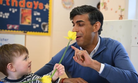 Rishi Sunak smells a flower in a nursery