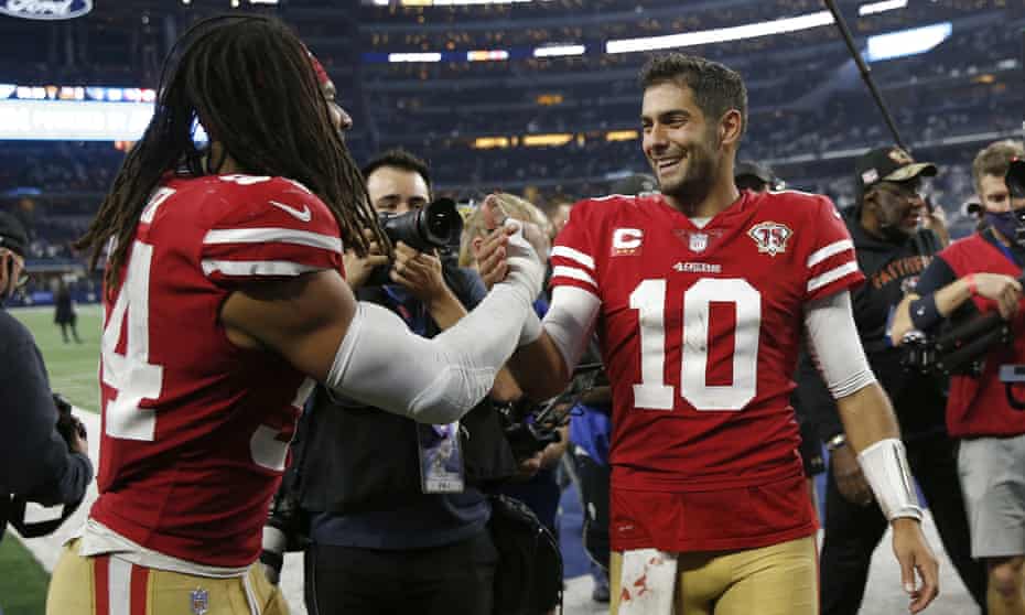 San Francisco 49ers linebacker Fred Warner, left, celebrates with quarterback Jimmy Garoppolo after the 49ers defeated the Dallas Cowboys