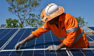 Northern Territory worker installs solar panels in Daly River