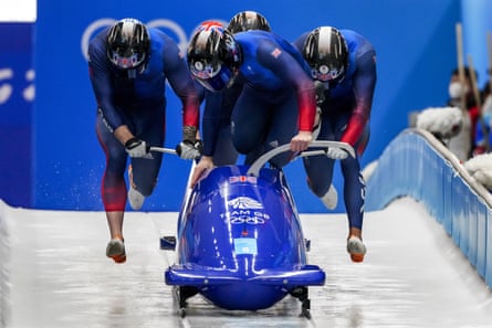 Team GB’s Brad Hall, Taylor Lawrence, Nick Gleeson and Greg Cackett push a bobsleigh.
