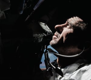 walter cunningham looks out of the command module during Apollo 7’s 11-day orbit of earth