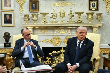 Friedrich Merz listens as Donald Trump speaks to reporters in the Oval Office