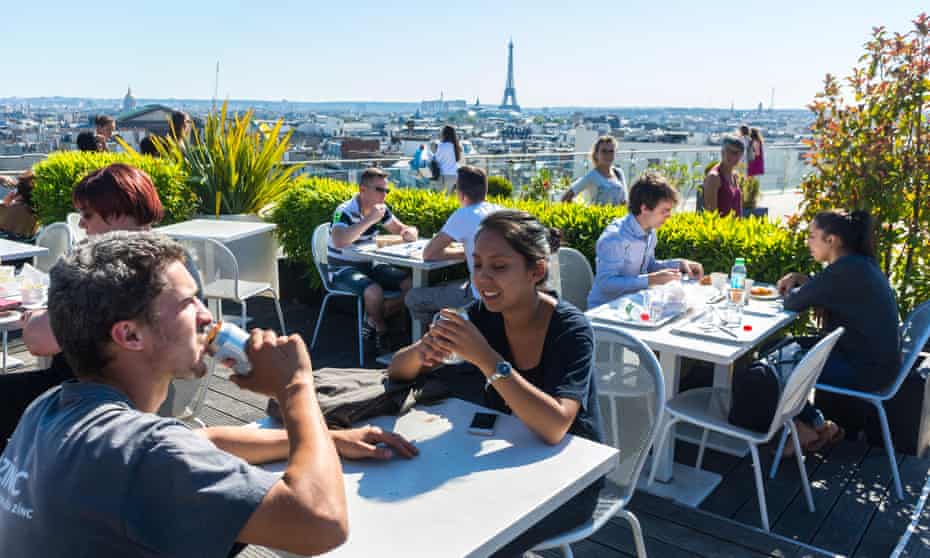 Diners at a Parisian rooftop cafe