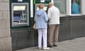 Two pensioners at a cash machine in Falmouth, Cornwall<br>GWYR1C Two pensioners at a cash machine in Falmouth, Cornwall