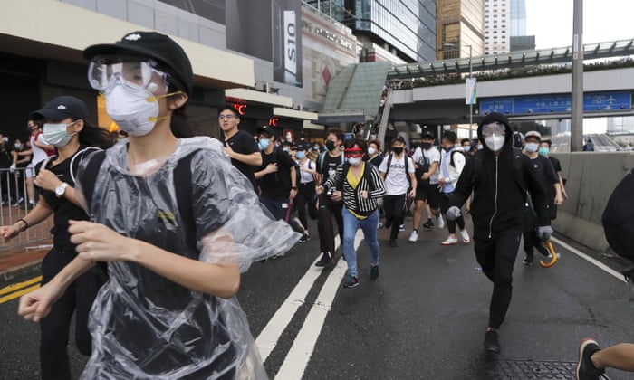 Protestors run near the Legislative Council in Hong Kong as the administration prepared to open debate on a highly controversial extradition law.