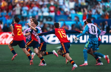Spain’s substitutes run onto the pitch in celebration as the final whistle blows in the World Cup final